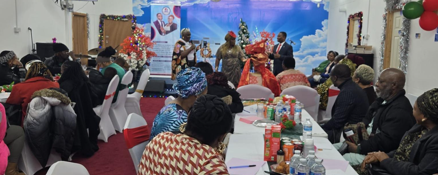 Divine Homes prayer meeting in progress at the community hall